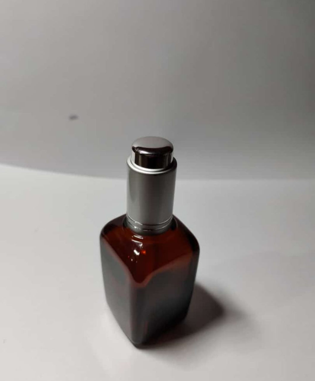 CP7249 50ml Amber square glass bottle with silver press pump